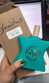 Bond No. 9 Greenwich Village Eau de Parfum fragrance bottle displayed with elegant packaging and floral accents.