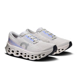 Women’s On Cloudmonster 3 road running shoes with grey and pink accents, showcasing the sneaker’s breathable mesh upper and cushioned sole.
