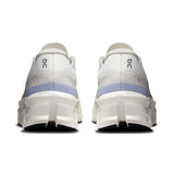 On Cloudmonster 2 women's road running shoes in ivory and Nimbus, featuring a cushioned sole and sleek design.