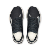 Women's On Cloudboom Strike road running shoes with lightweight design and breathable mesh in black and white.