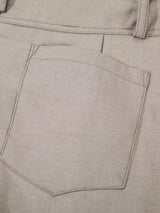 Men's high-waisted wide-leg pleated casual pants in neutral fabric, styled casually for a comfortable, modern look.