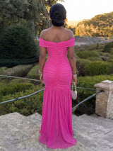 Off-shoulder ruched mermaid maxi dress by Trendsi featuring a fitted silhouette and elegant design, shown on a model.