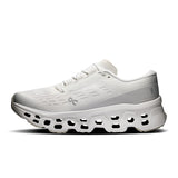 Women's On Cloudmonster 3 road running shoes in black and white, featuring cushioned soles and breathable mesh upper.