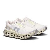 Women's On Cloudmonster 3 road running shoes with cushioned soles and breathable mesh upper, designed for comfort and performance.