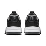 On THE ROGER Clubhouse Pro 2 men's tennis shoes in black with white accents, featuring breathable mesh and supportive sole.