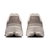 On Cloudmonster Void women's active life shoe in pearl and desert, featuring a sleek design and cushioned sole for comfort.