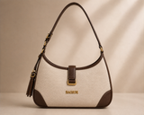 Cream and brown two-tone shoulder bag with tassel detail from Bagsor, featuring a stylish design and adjustable strap.
