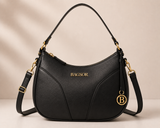 Black curved handbag by Bagsor with gold-tone hardware, featuring a stylish design and elegant details.