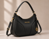 Black curved handbag by Bagsor with gold-tone hardware, featuring sleek design and top handle, perfect for stylish outings.