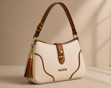Cream and tan two-tone shoulder bag with tassel detail from Bagsor, featuring a stylish design and adjustable strap.