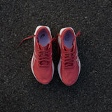 Women's ASICS Sonicblast tempo trainers in black and pink, featuring breathable mesh uppers and cushioned soles for running.